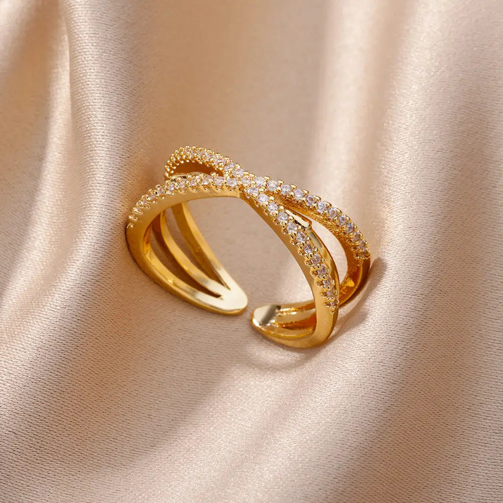 ALT da imagem principal: Anel cruzado dourado ajustável em aço inoxidável com detalhes brilhantes